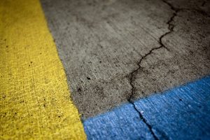 parking lot maintenance needed for cracked pavement